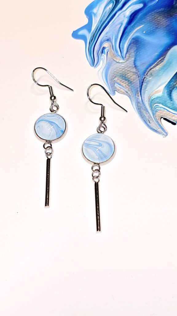 orecchini artigianali fluid art pendenti in acciaio inossidabile cabochon rotondo in vetro 12mm vernice acrilica perlescente colore celeste e azzurro. autore AmarAnto Arte